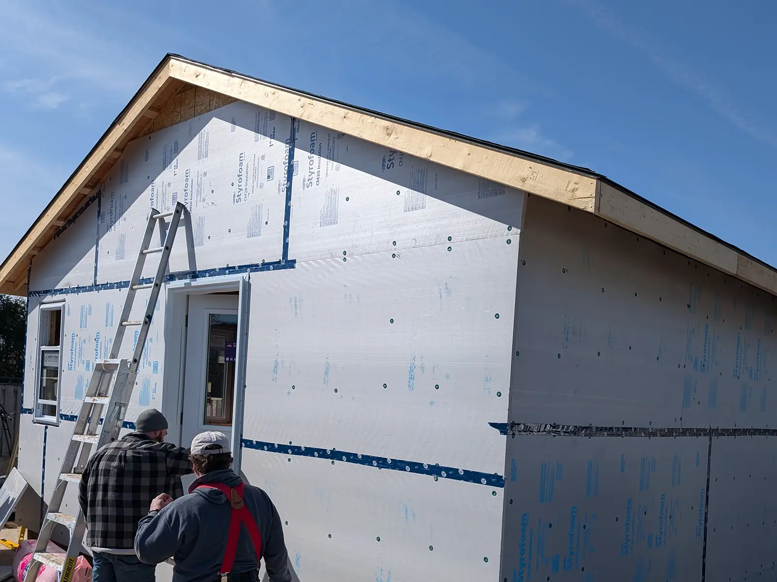 Home additions and extensions project under construction by MD Construction showing new exterior framing.