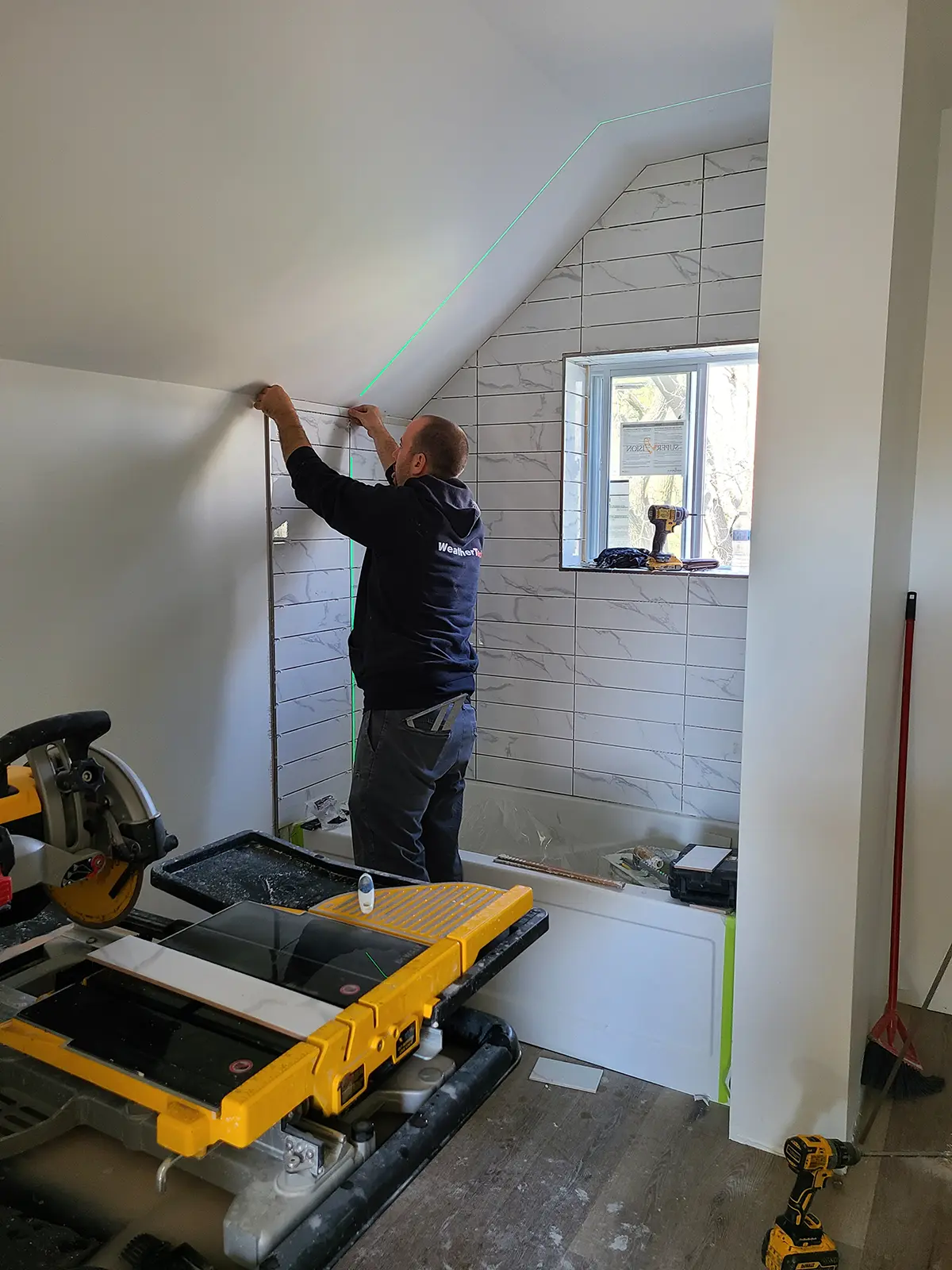 MD-Construction_projects_Omemee-Street-39_1200 Tile installation during a bathroom remodel as part of a home renovations project by MD Construction