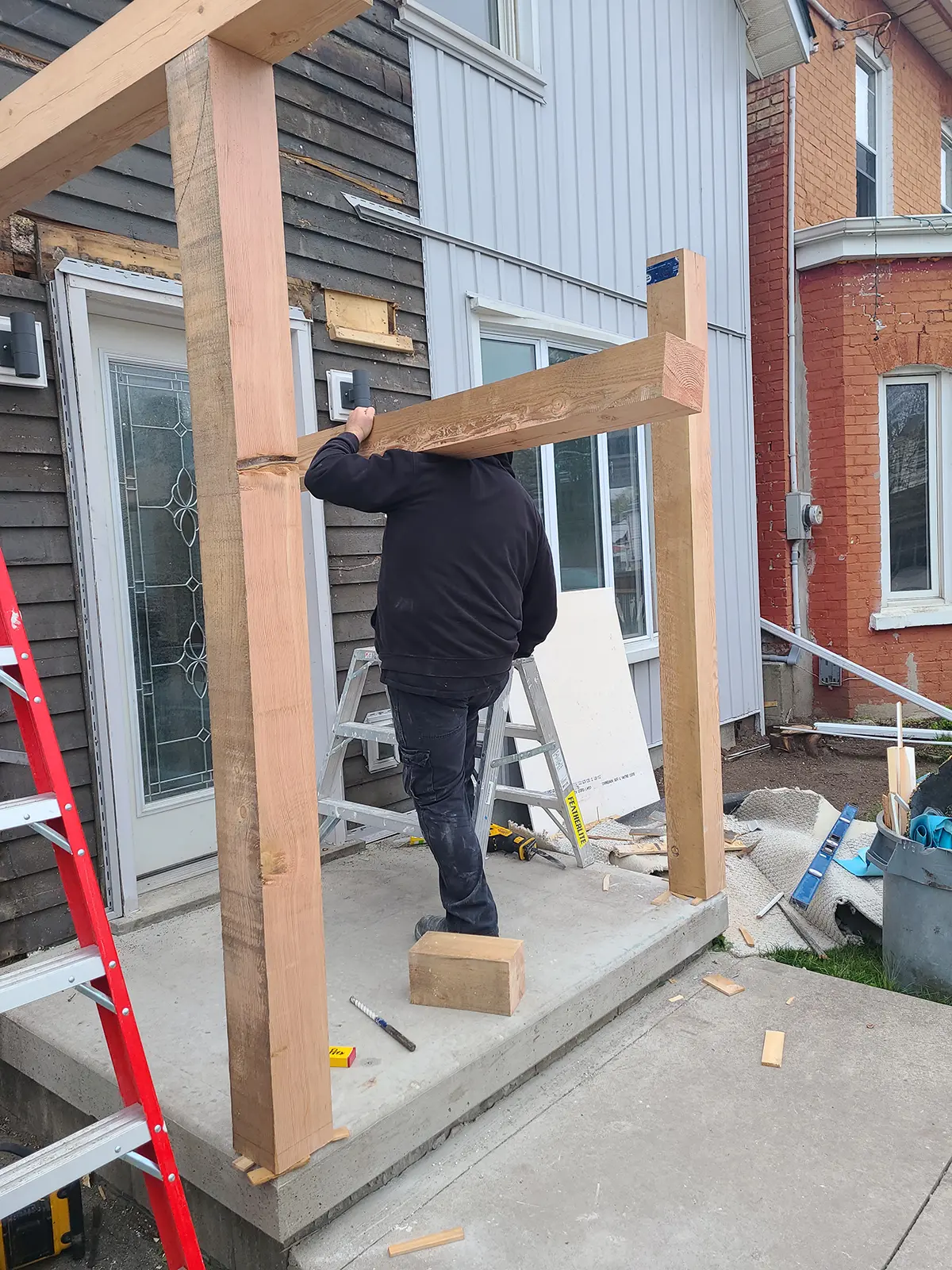 MD Construction team performing exterior home upgrades during porch renovation.