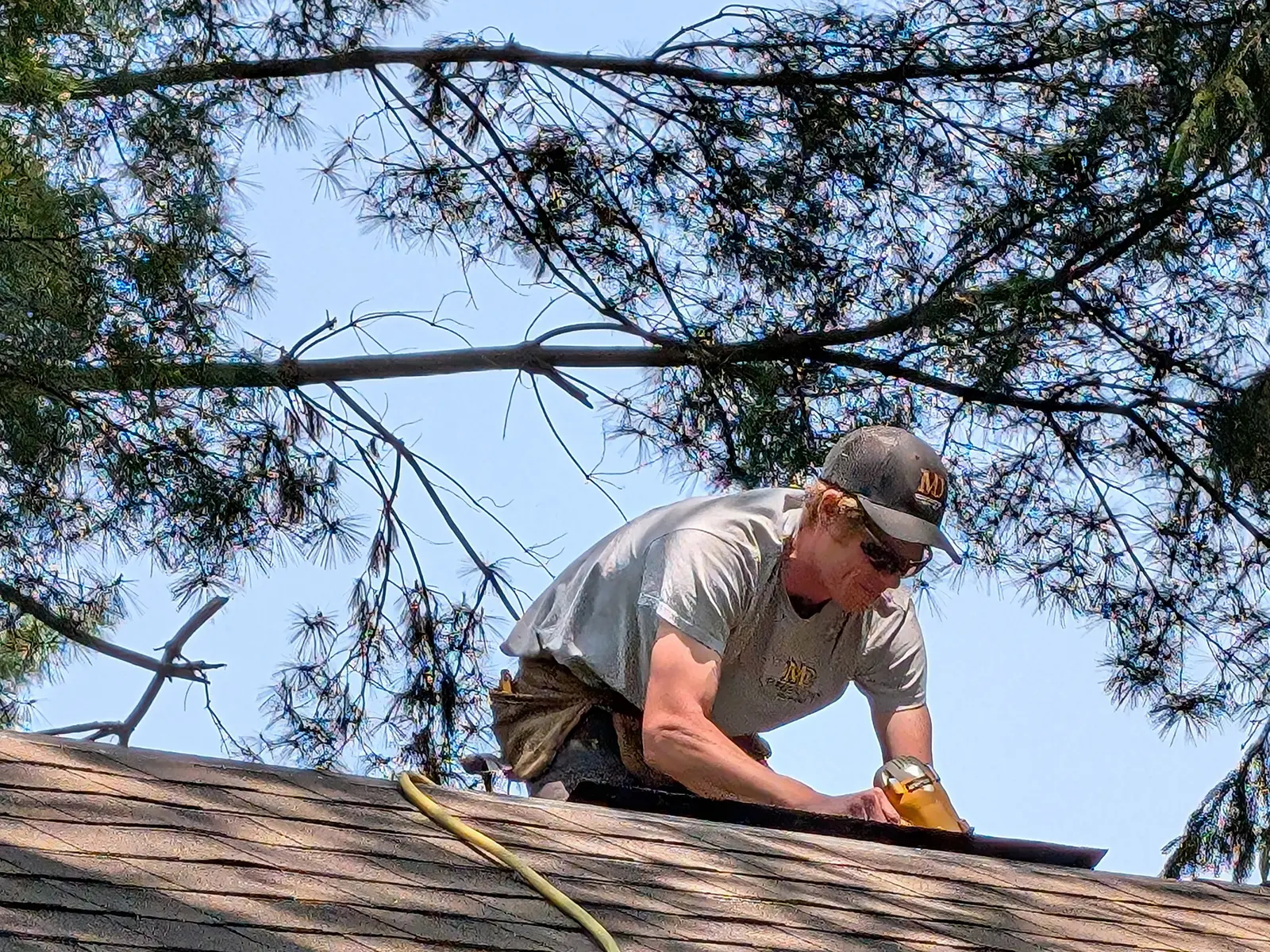 Professional home repair work by MD Construction showing roof maintenance and quality craftsmanship.