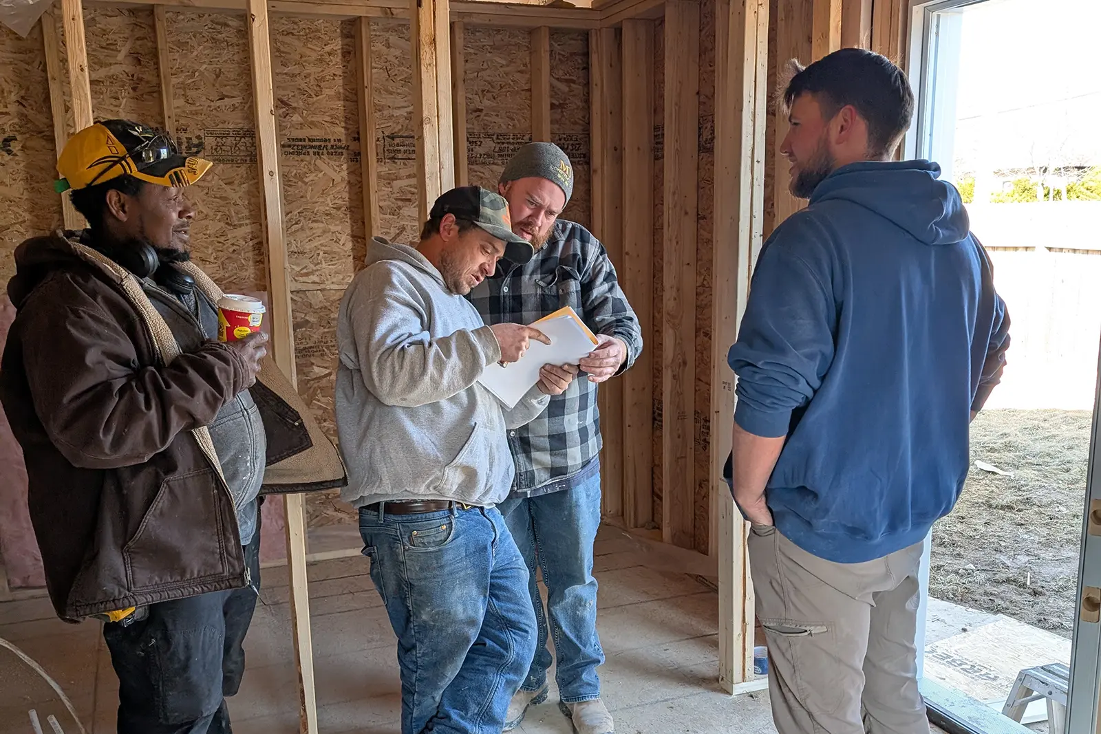 MD Construction team reviewing construction plans on-site.