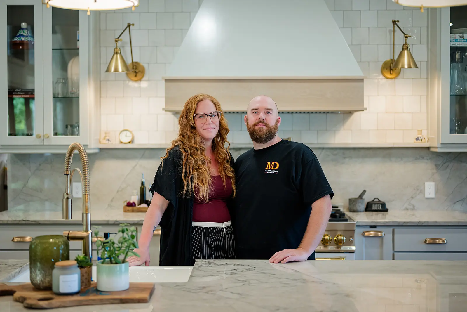 Tom and Jocelyn, owners of MD Construction, standing in a new kitchen in Port Stanley, Ontario